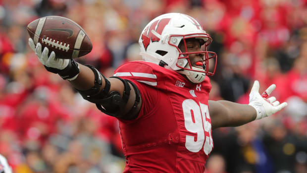 Wisconsin defensive lineman Keeanu Benton celebrates a fumble recovery.